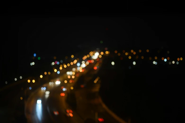 a city street filled with lots of traffic at night, a tilt shift photo, unsplash, medium format. soft light, freeway, overcast bokeh - c 5, tilt shift”