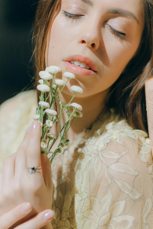 a close up of a person holding a flower, a colorized photo, inspired by Elsa Bleda, aestheticism, hailee steinfeld, kiko mizuhara, engagement ring ads, mushrooms grow from the body