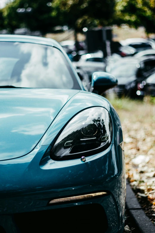 a blue sports car parked on the side of the road, inspired by Harry Haenigsen, unsplash, renaissance, close up head shot, festivals, lined up horizontally, upscaled to high resolution