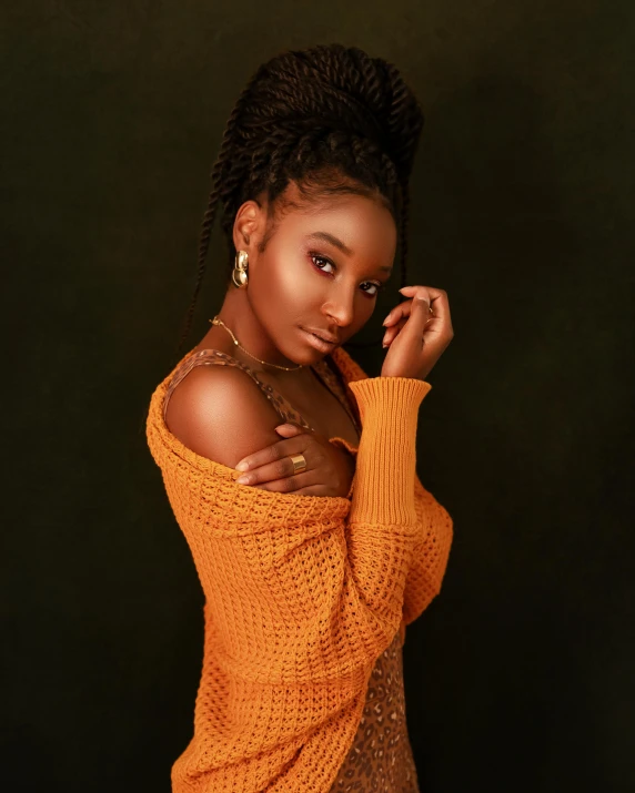 a woman in an orange sweater posing for a picture, by Chinwe Chukwuogo-Roy, trending on pexels, dark brown skin, willow smith young, brown:-2, studio photo