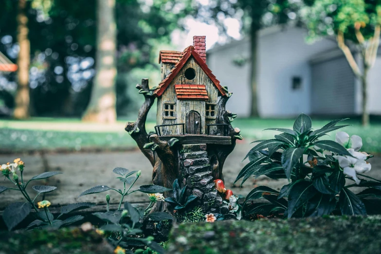 a fairy house sitting on top of a tree stump, a tilt shift photo, pexels contest winner, in a garden of a house, 3d asset, multi - coloured, small