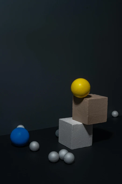a box sitting on top of a pile of balls, inspired by Bauhaus, unsplash, square shapes, chalk, floats in space, studio shot