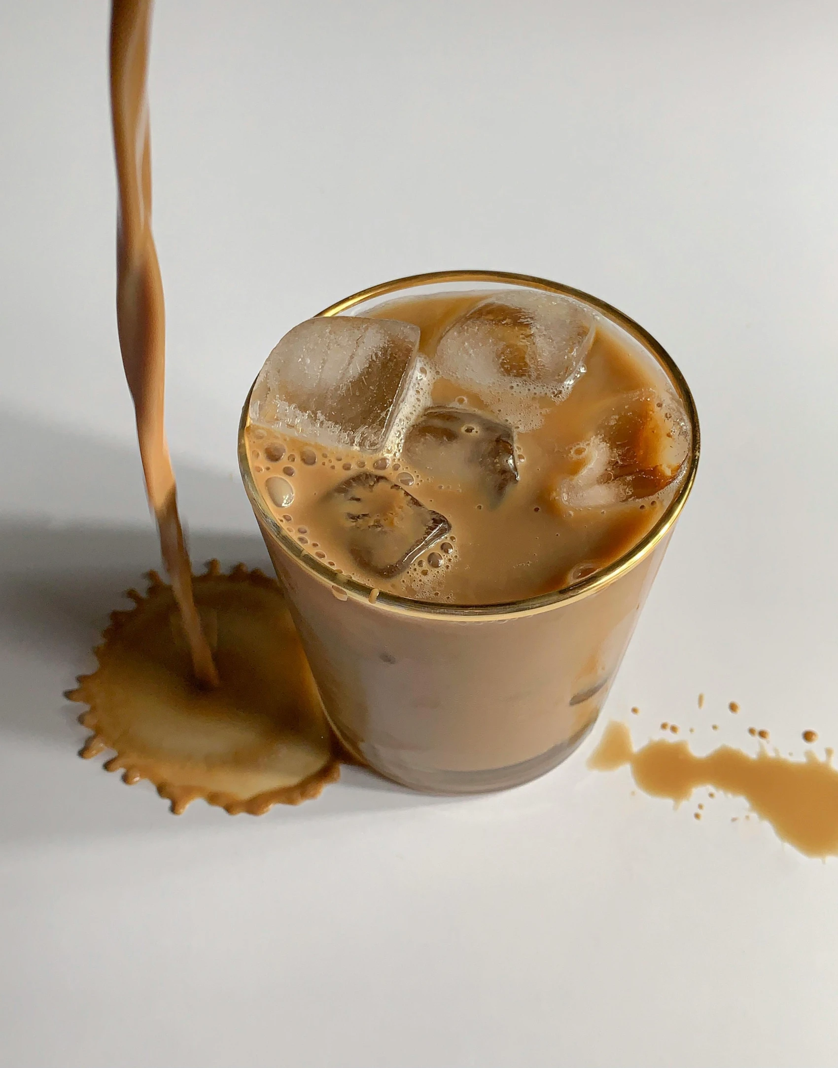 a close up of a drink being poured into a glass, trending on unsplash, photorealism, milk and mocha style, thumbnail, ignant, lgbtq