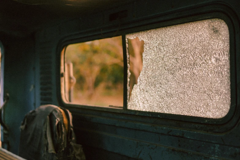 a close up of a window on a bus, by Elsa Bleda, pexels, auto-destructive art, next to an rv, gunfire, wrecked, bulli