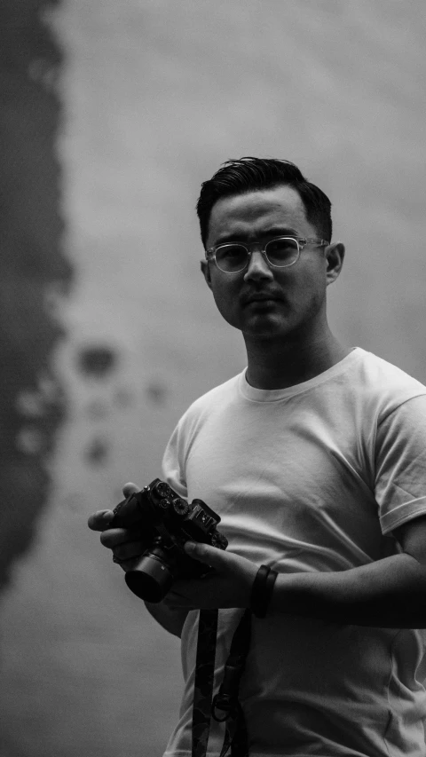 a black and white photo of a man holding something, inspired by Rudy Siswanto, holding controller, avatar image, ash thorp khyzyl saleem, low quality photo