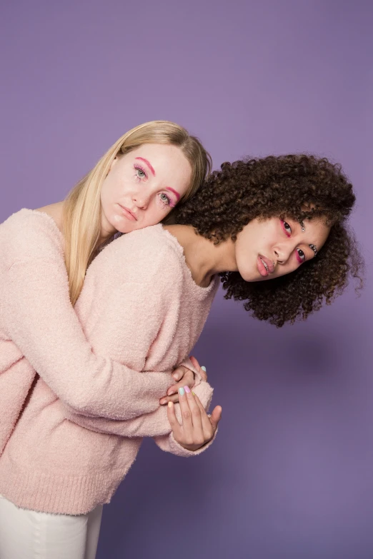 a couple of women standing next to each other, trending on pexels, antipodeans, pink and purple, cuddly, mixed race, very pale