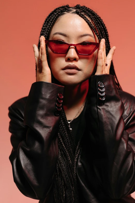 a woman in a leather jacket and sunglasses, inspired by Zhu Da, trending on pexels, visual art, wearing red, studio lit, half asian, promotional image