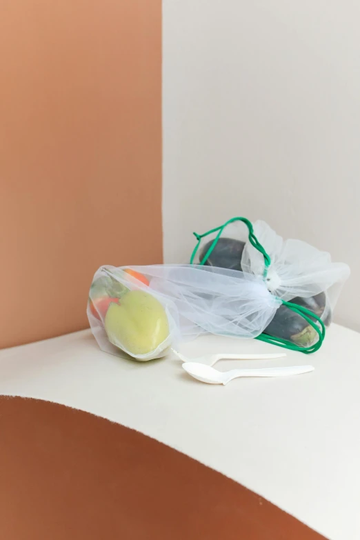 a tennis racket sitting on top of a table, a still life, by Jessie Algie, plasticien, bags, green, 3 - piece, getting groceries