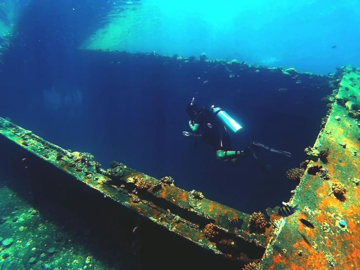 a person scubas in a deep blue water, shipwrecks, instagram photo, thumbnail, medium angle