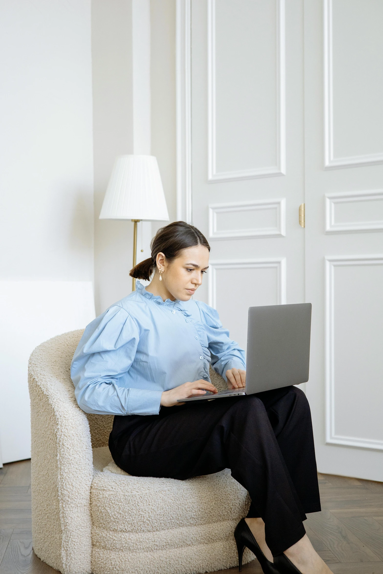 a woman sitting in a chair using a laptop, by Nicolette Macnamara, pexels, renaissance, wearing a light blue shirt, puff sleeves, julia sarda, alexandria ocasio - cortez