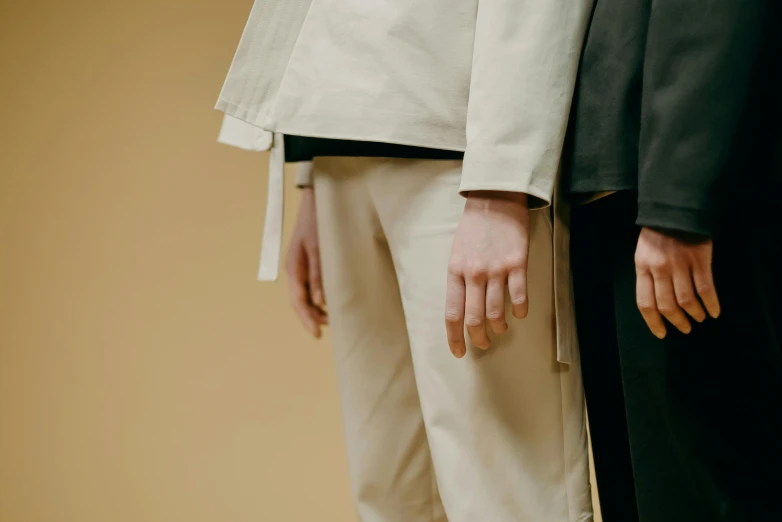 a couple of people standing next to each other, by Nina Hamnett, trending on unsplash, bauhaus, khakis, wearing a haori, close-up on legs, ignant