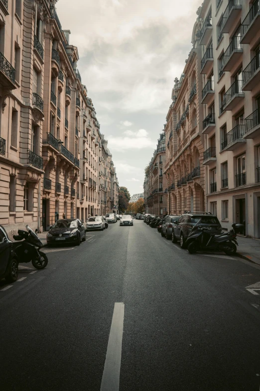 a street lined with parked cars next to tall buildings, pexels contest winner, paris school, french village exterior, neoclassical, high quality photo