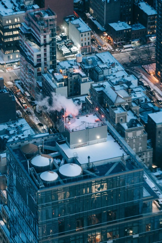 an aerial view of a city at night, by Daniel Seghers, unsplash contest winner, graffiti, (snowy new york in background), steam pipes, rooftop, gif