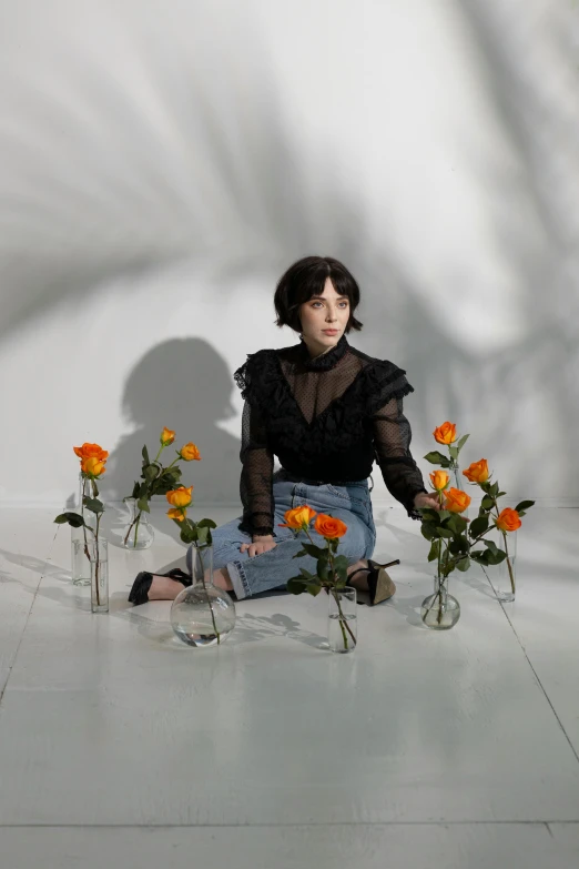 a woman sitting on the floor surrounded by flowers, an album cover, by Winona Nelson, unsplash contest winner, realism, kiko mizuhara, in front of white back drop, alice cullen, in a short round glass vase