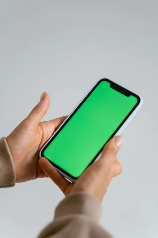 a person holding a phone with a green screen, trending on pexels, color field, square, on grey background, greens), 16k resolution:0.8