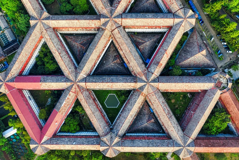 an aerial view of a building surrounded by trees, an album cover, inspired by Ai Weiwei, unsplash contest winner, renaissance, intricate triangular designs, star roof, closeup, shipibo