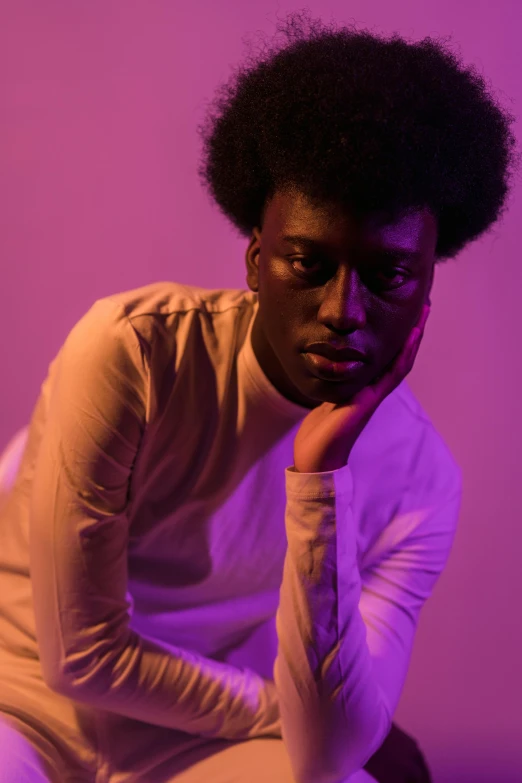 a man sitting on a stool with his hand on his chin, an album cover, by Winona Nelson, pexels contest winner, afrofuturism, soft purple glow, yasuke 5 0 0 px models, with afro, soft light 4 k in pink