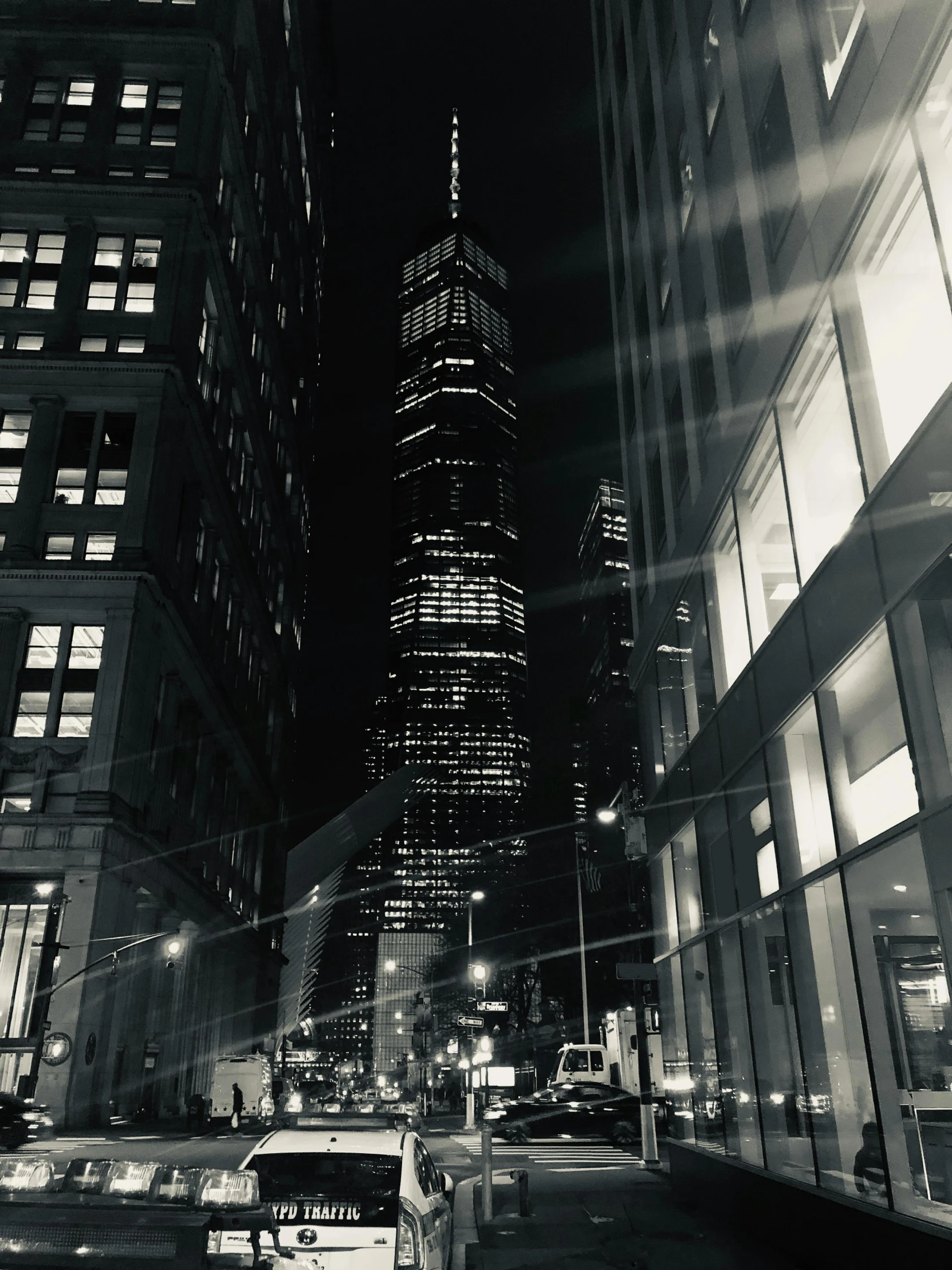 a black and white photo of a city at night, a black and white photo, pexels contest winner, trump tower, instagram story, view from the street, stacked image