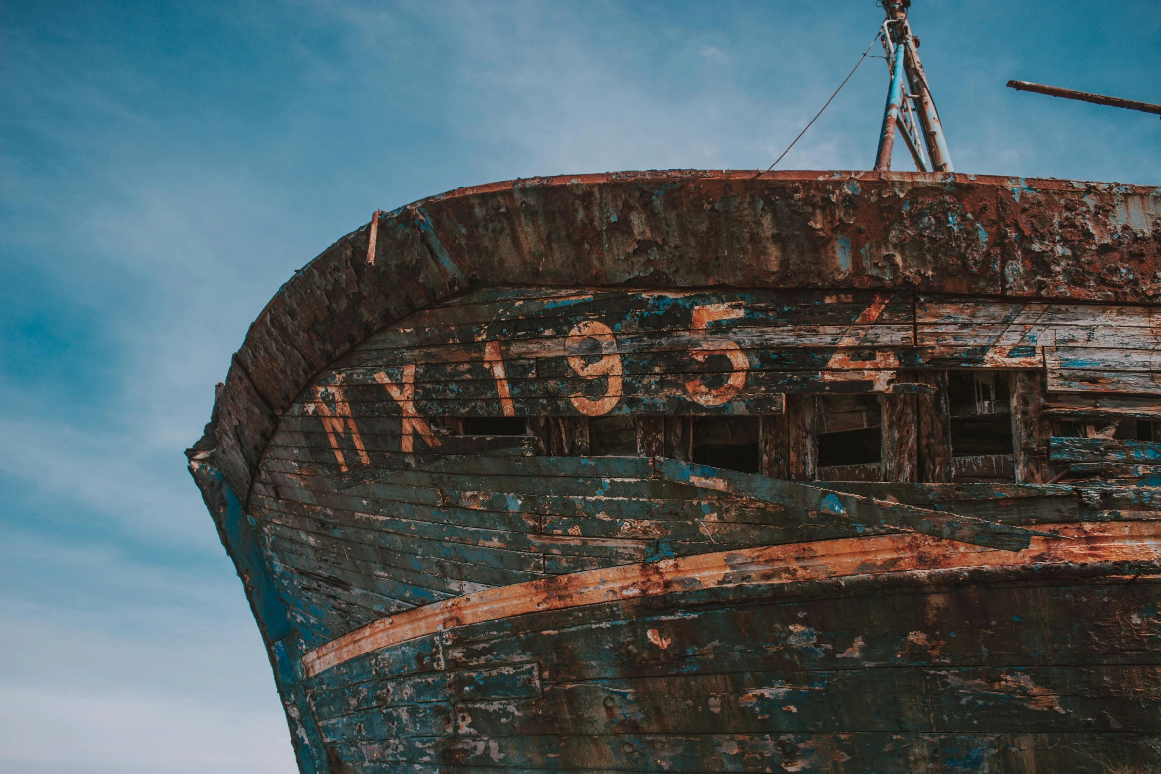 an old boat sitting on top of a sandy beach, pexels contest winner, graffiti, looking upward, copper oxide and rust materials, blue, profile pic
