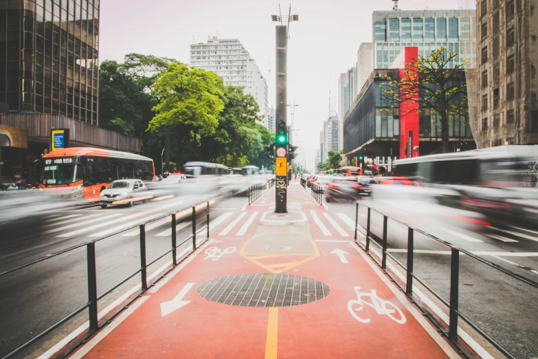 a street filled with lots of traffic next to tall buildings, by Ceferí Olivé, pexels contest winner, visual art, square, wide greenways, brazilian, 🚿🗝📝