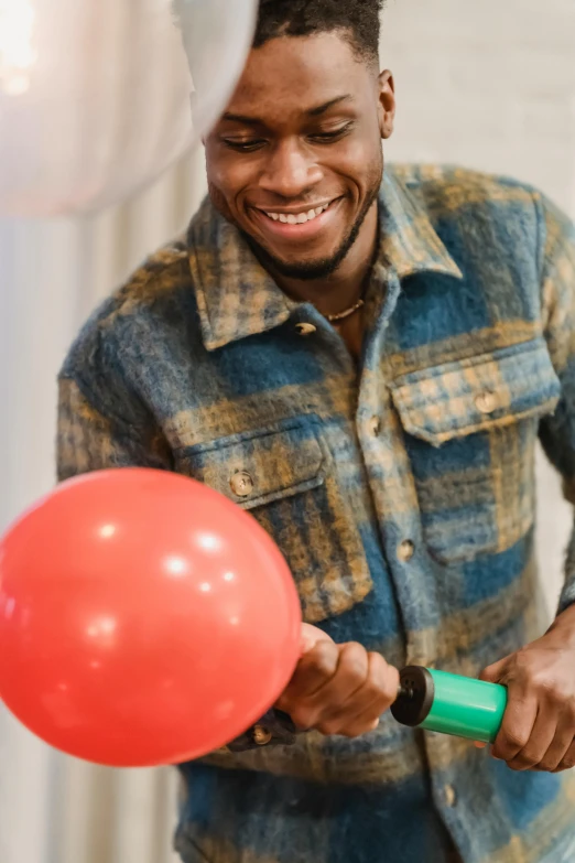 a close up of a person holding a balloon, playing games, black man, smiling, carrying two barbells