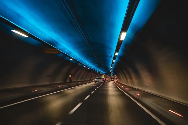 a car driving through a tunnel at night, by Julia Pishtar, unsplash contest winner, glowing blue interior components, concert, multiple stories, thumbnail