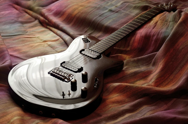 a white guitar sitting on top of a bed, pexels contest winner, steel gray body, glass and metal : : peugot onyx, silver skin, scimitar