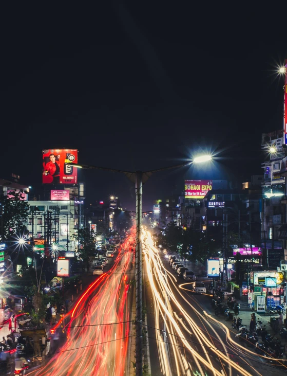 a city street filled with lots of traffic at night, indore, photo of futuristic cityscape, unsplash photography, square