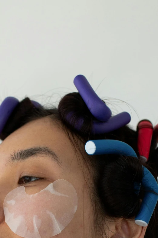 a woman with plastic tape on her face, an album cover, inspired by Man Ray, trending on pexels, purple tubes, hair are curled wired cables, wenjun lin, detailed product image