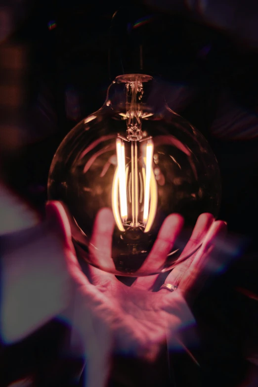 a person holding a light bulb in their hand, glowing epicentre, renaissance lighting, promo image, full of details