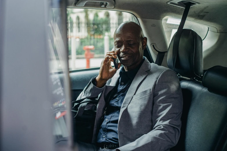 a man sitting in a car talking on a cell phone, lance reddick, ceo, alphonse fly, profile image