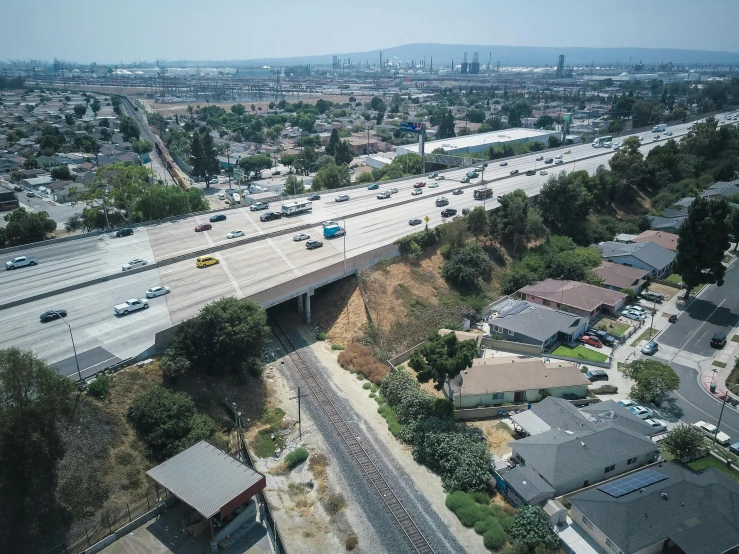 an aerial view of a highway with cars driving on it, unsplash, photorealism, 1600 south azusa avenue, all buildings on bridge, 4k photo”, realistic”