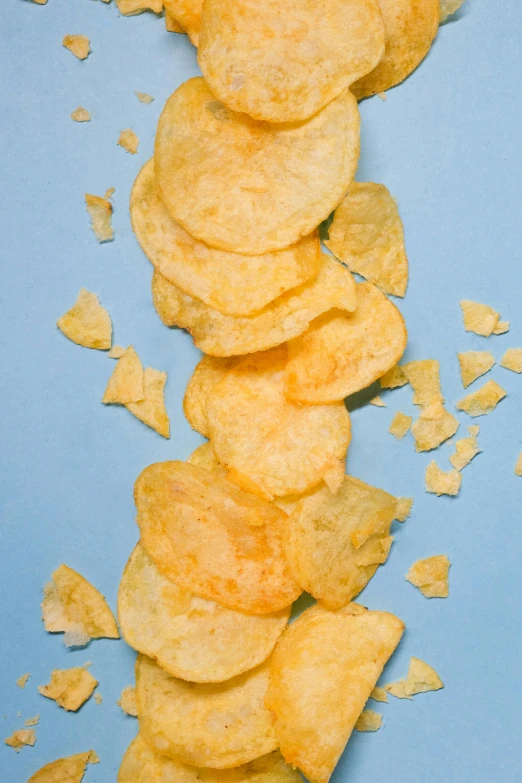 a pile of potato chips on a blue surface, inspired by Chippy, ffffound, promo image, essence, rectangle