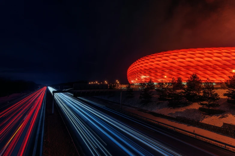 a stadium lit up at night with long exposure, a picture, by Sebastian Spreng, unsplash contest winner, glowing red, munich, photobash, vehicle