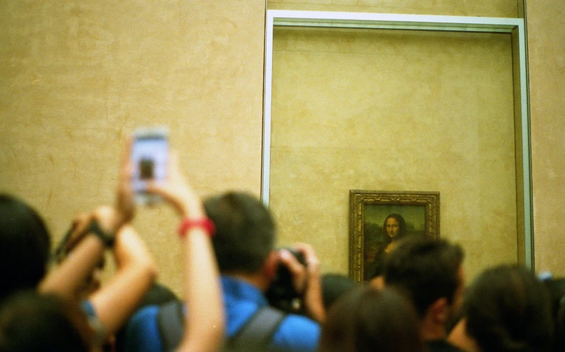 a group of people taking pictures of a painting, by Leonardo da Vinci, trending on unsplash, monalisa, face in-frame, in paris, martin parr