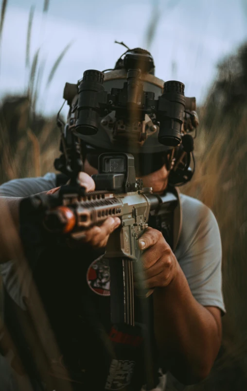 a man with a gun in a field, pexels contest winner, dressed in tactical armor, optics, indoor shot, action sports