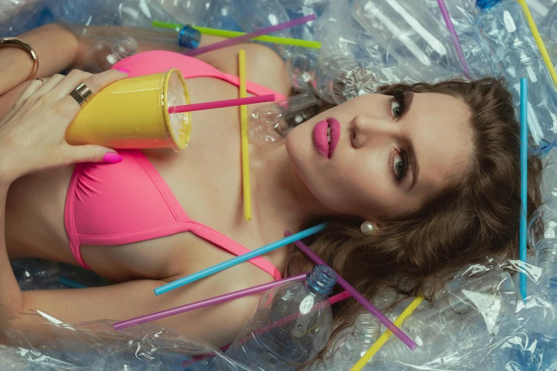a woman in a pink bikini surrounded by plastic straws, inspired by David LaChapelle, trending on pexels, plasticien, lipstick, cups and balls, olya bossak, soda themed girl