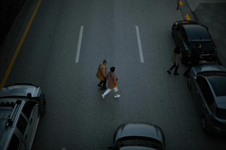a couple of people walking across a street, by Niko Henrichon, pexels contest winner, top down, vancouver, highway, korean artist