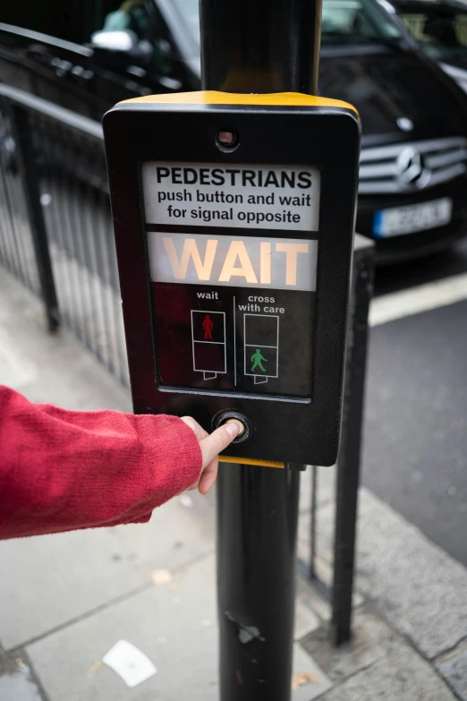 a person points at a pedestrian crossing sign, by Steve Prescott, graffiti, control panels, black, square, without text