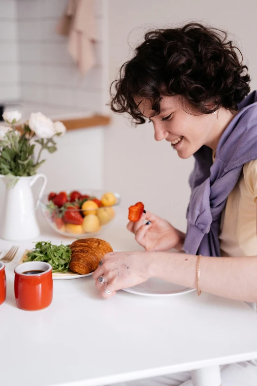 a woman sitting at a table with a plate of food, profile image, food styling, wholesome, paprika