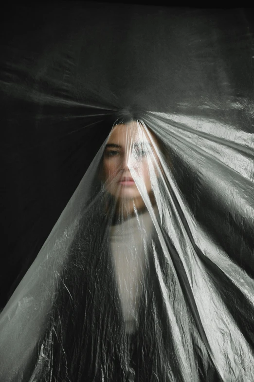 a woman with long hair wrapped in plastic, by Adam Marczyński, unsplash contest winner, fully covered in drapes, girl with white eyes, dressed in dark garment, rectangle