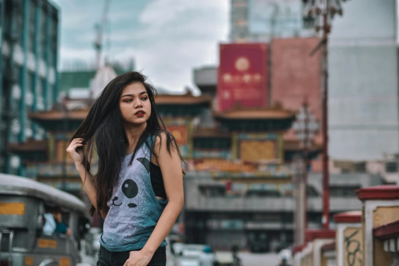 a woman standing in the middle of a street, pexels contest winner, graffiti, beautiful young himalayan woman, wearing : tanktop, avatar image, malaysian