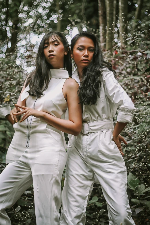 a couple of women standing next to each other, an album cover, inspired by Sasha Putrya, trending on pexels, sumatraism, jumpsuit, casual white garment, 5 0 0 px models, 👅 👅