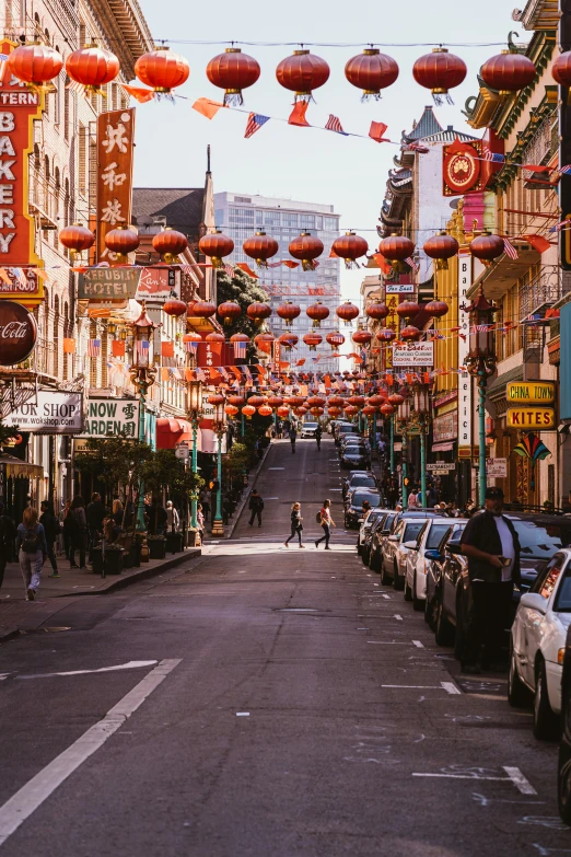a street filled with lots of cars next to tall buildings, trending on unsplash, chinatown bar, hanging lanterns, sf, asian women