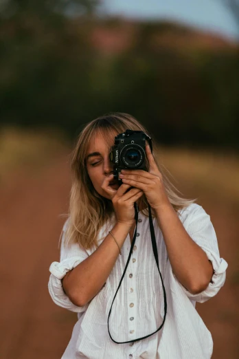 a woman taking a picture with a camera, a picture, inspired by Elsa Bleda, unsplash contest winner, lovingly looking at camera, portrait pose, landscape photo, medium portrait soft light