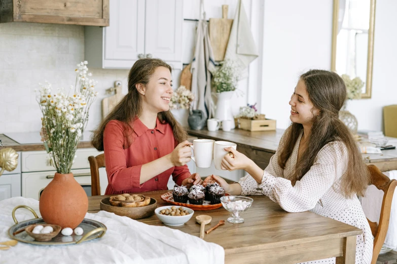 two women sitting at a table sharing a cup of coffee, pexels contest winner, happening, cute kitchen, teenager girl, 15081959 21121991 01012000 4k, manuka