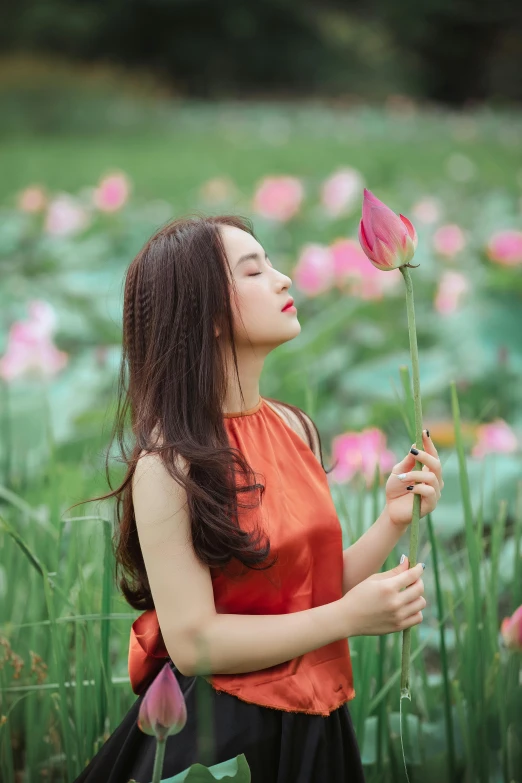 a woman standing in a field holding a flower, by Tan Ting-pho, pexels contest winner, standing gracefully upon a lotus, handsome girl, avatar image, she is korean