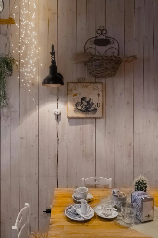 a dining room with a wooden table and chairs, a portrait, by Miyamoto, unsplash, fantasy bakery interior setting, arrendajo in avila pinewood, wires and lights, wall ]