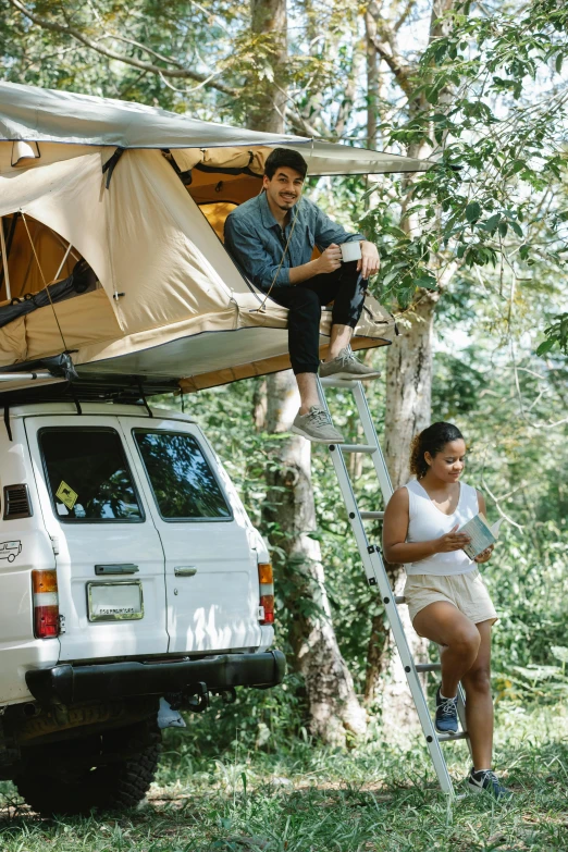 a couple of people that are sitting in the back of a truck, floral jungle treehouse, with a roof rack, tent, flatlay