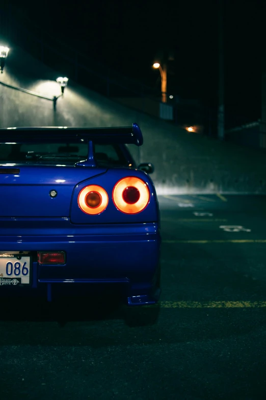 a blue sports car parked in a parking lot at night, pexels contest winner, in a modified nissan skyline r34, gif, back light, lo fi